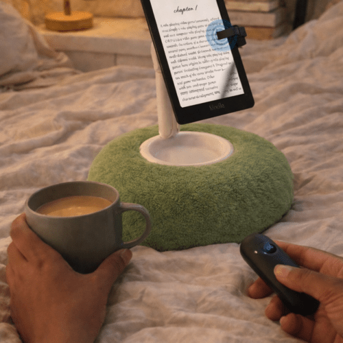 Hands-free Kindle holder with remote page turner set up for reading in bed